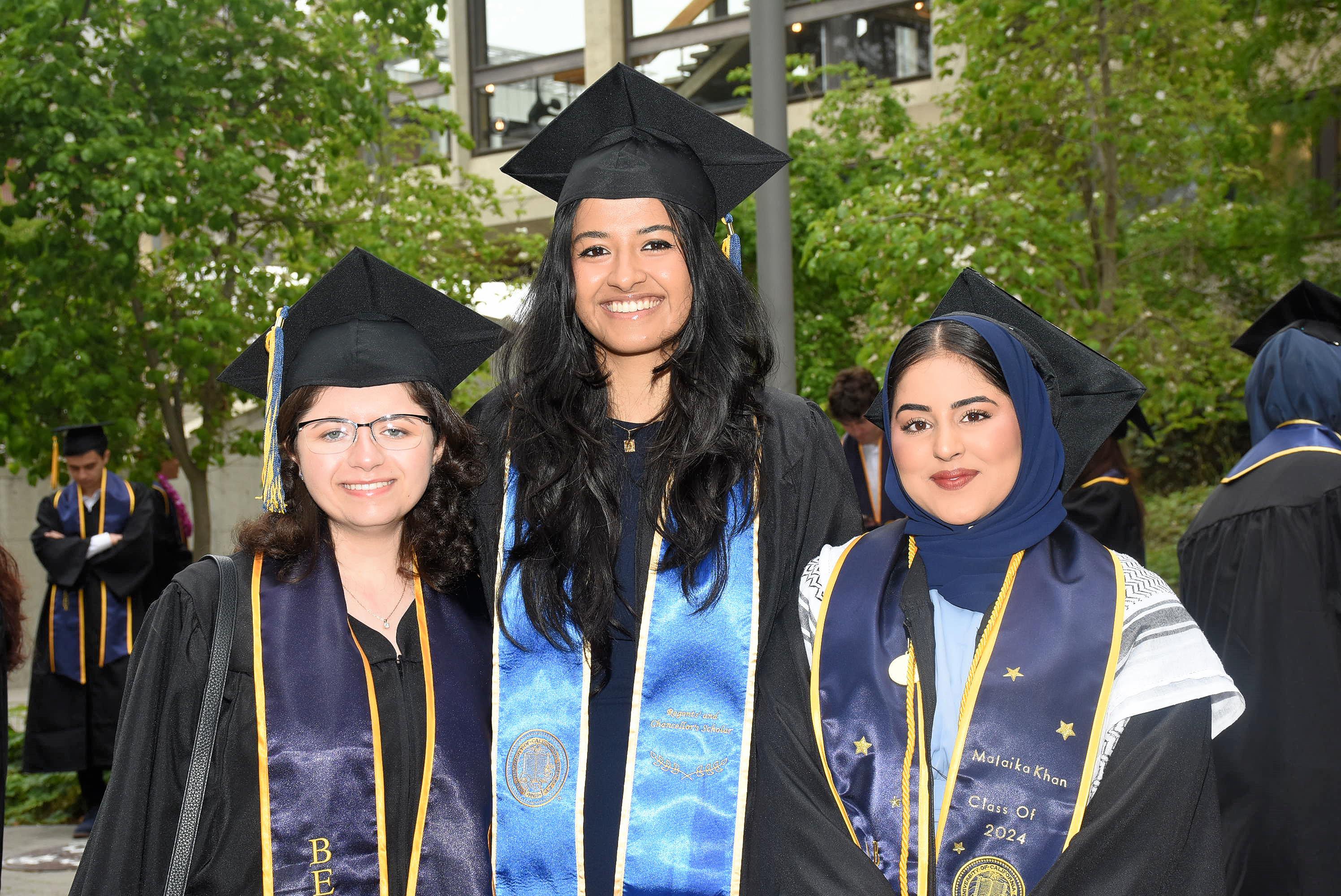 Three graduates in regalia