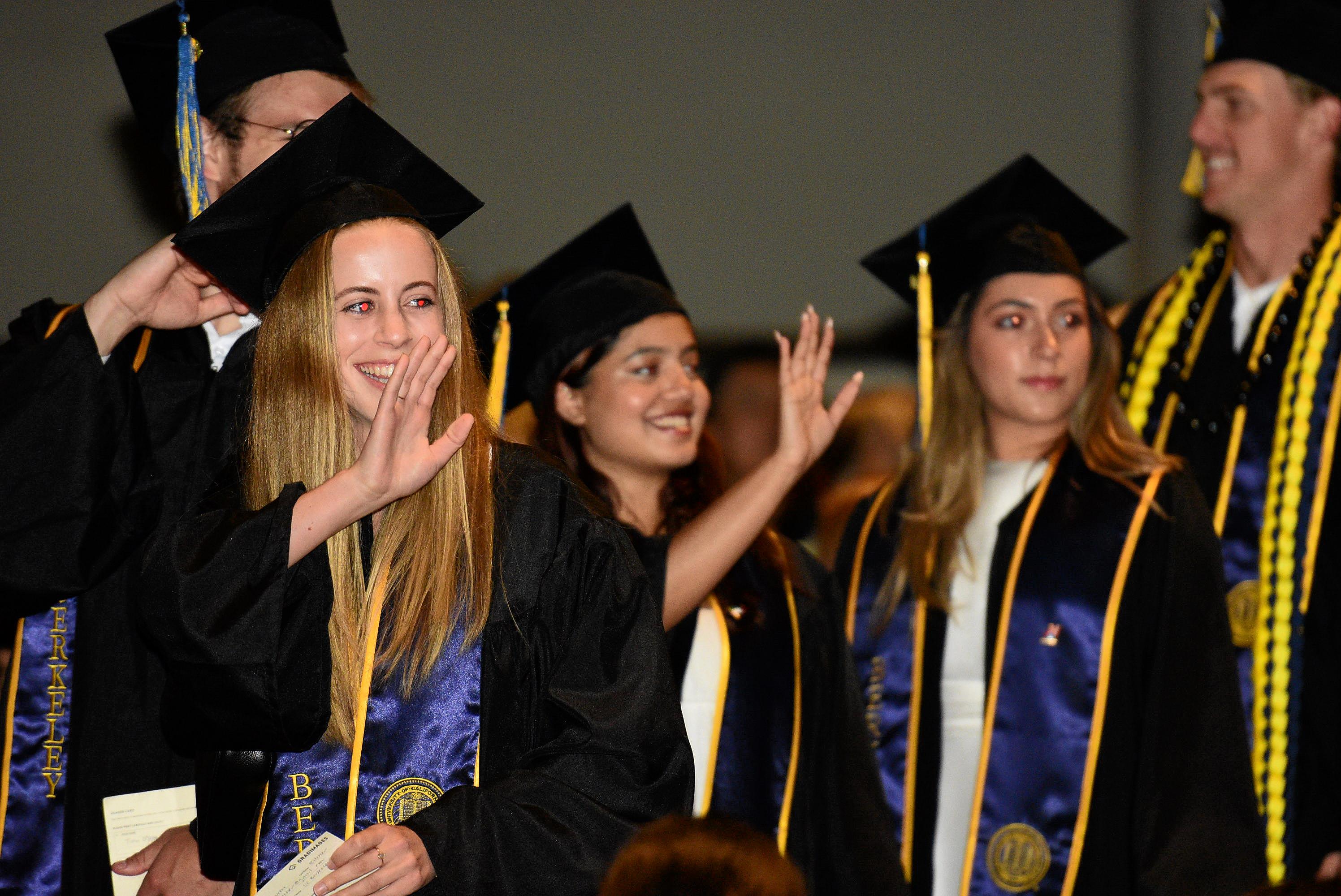 Grads wave to audience