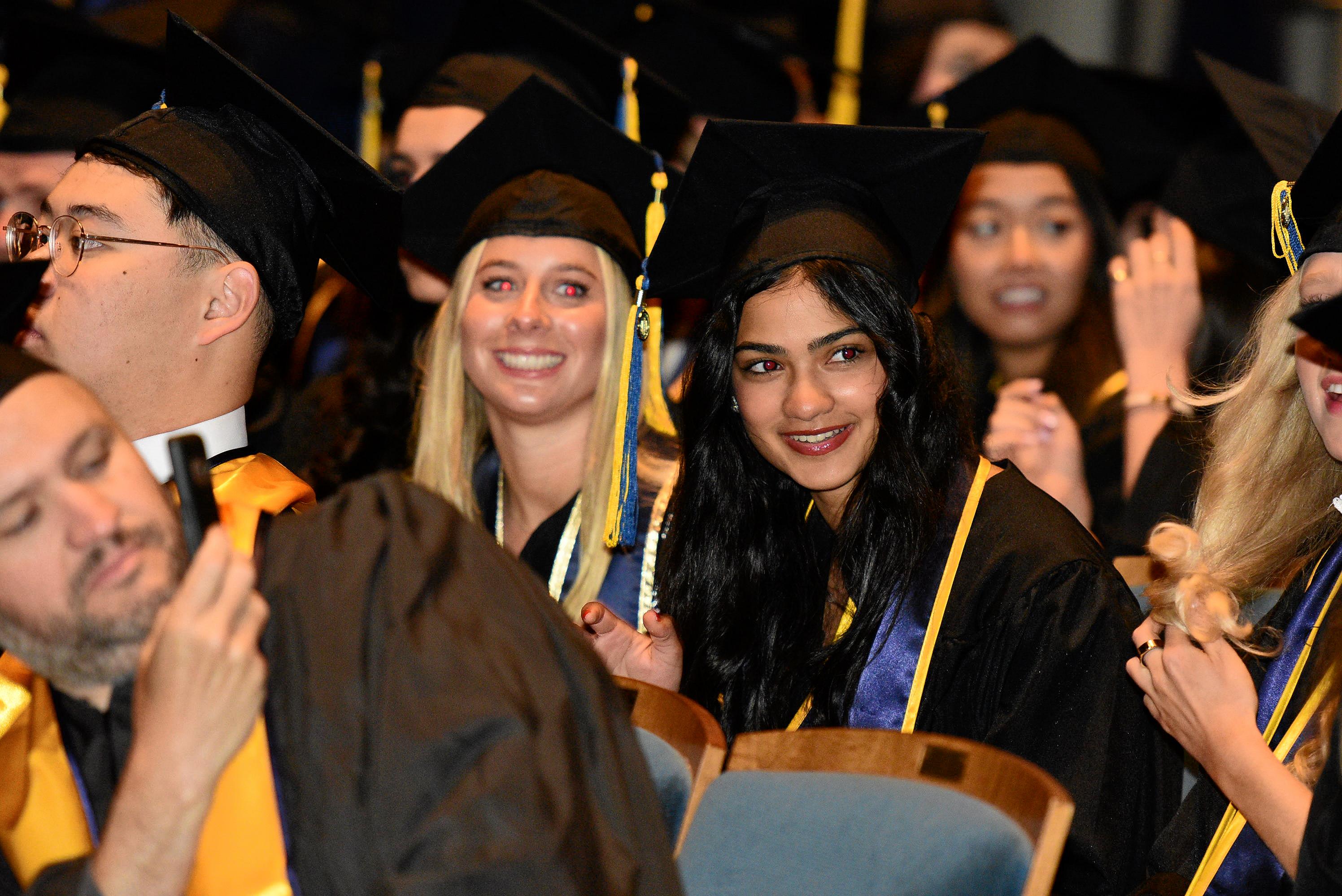 Graduates smile during commencement