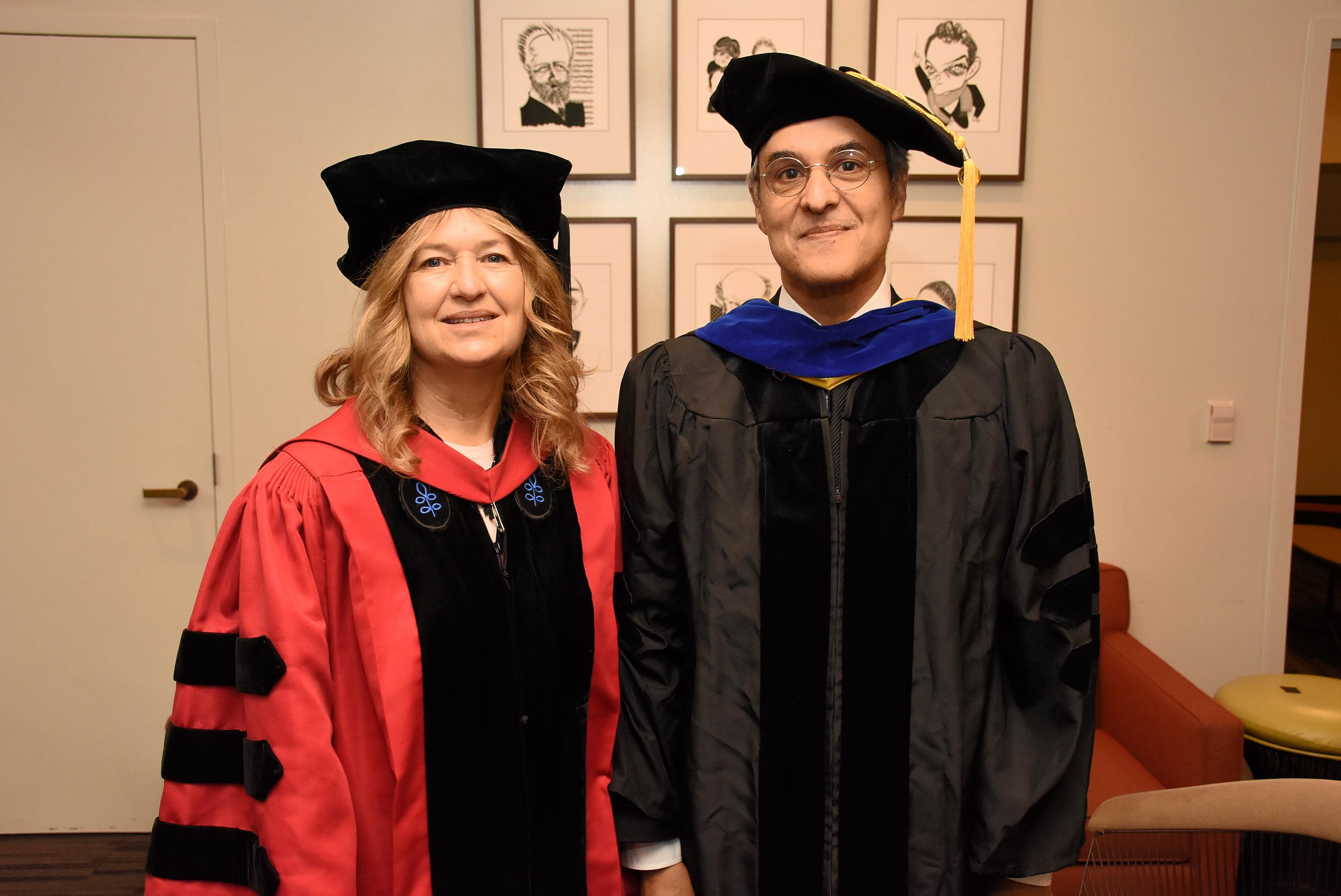 Two faculty members at commencement