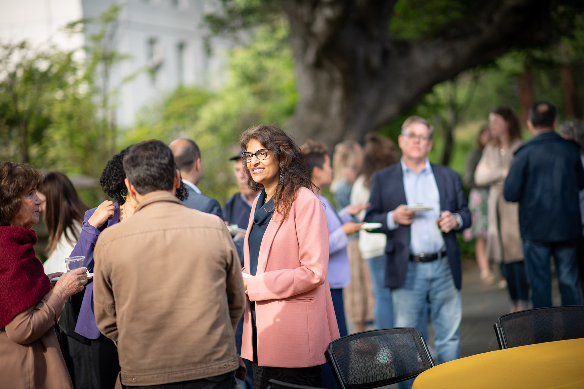 Candid shot of a person smiling, engaged in conversation with another person