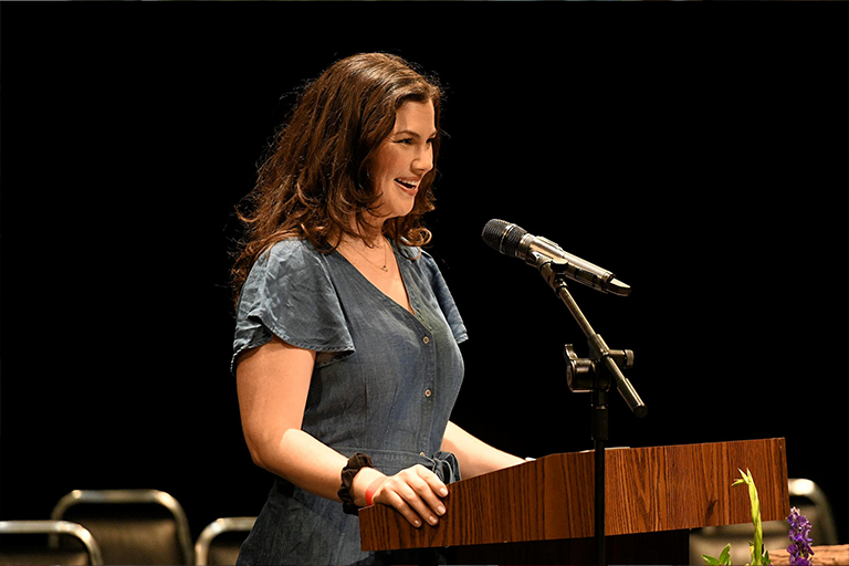 Woman smiles at podium