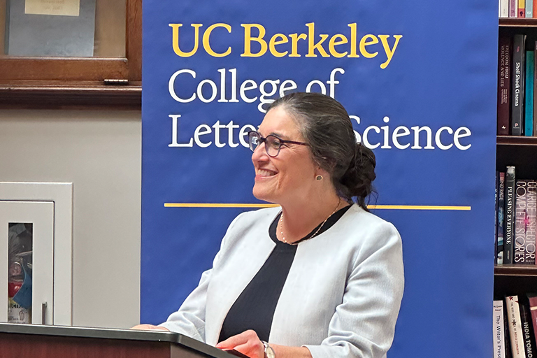 Woman smiling while speaking at a lectern