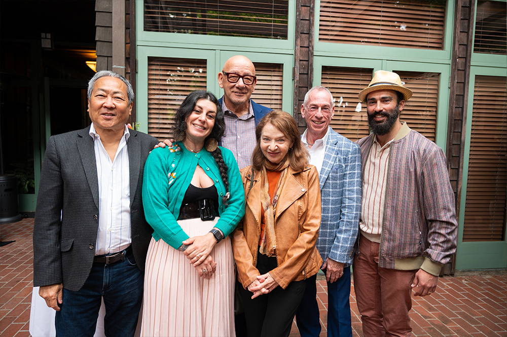 Group of people stand together outside