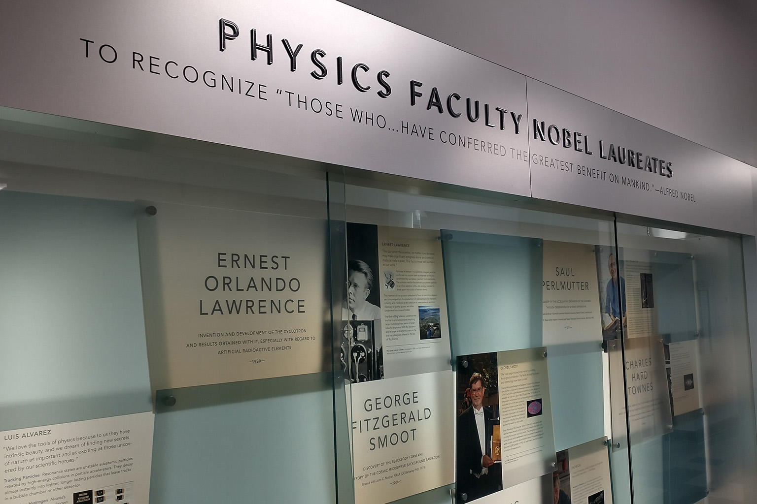 A display lists the physics department's Nobel laureates, including Ernest Orlando Lawrence and George Fitzgerald Smooth.
