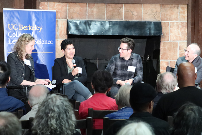 Panelists sit and talk at an event