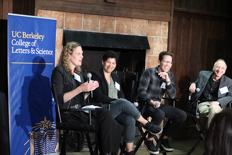 Four panelists speaking at an event 