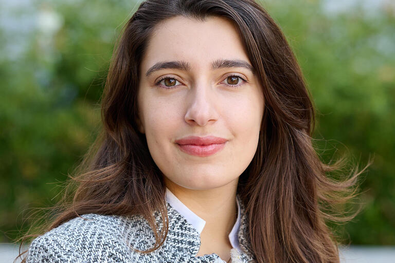 Headshot of a woman with brown hair and eyes