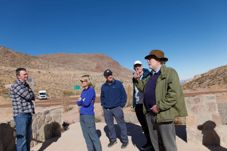 Dean Kahn speaks with four other visitors outside the Vera Rubin Observatory