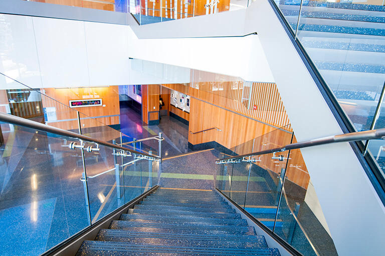 Stairways with metal railings and glass walls