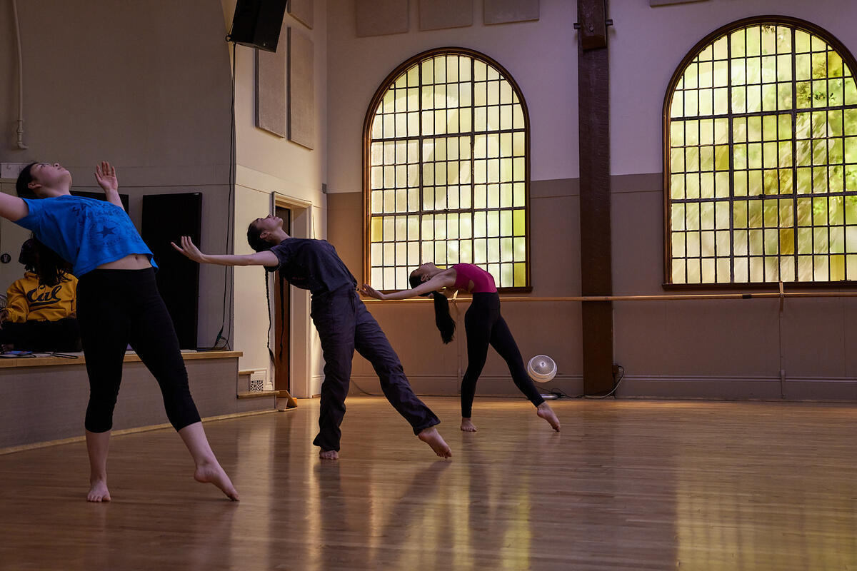 Three dancers practice on the wooden floors of Bancroft Dance Studio.