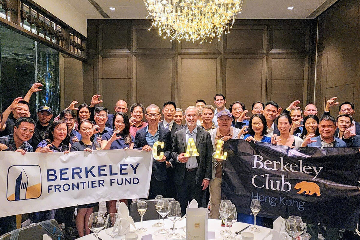 A group of people hold up signs reading "Berkeley Frontier Fund" and "Berkeley Club Hong Kong"