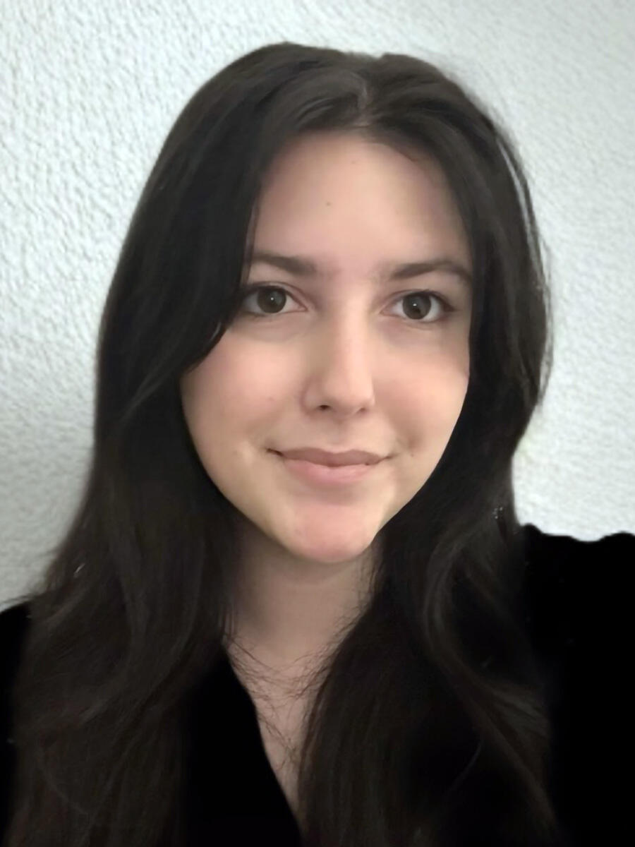 A woman with long, dark hair smiles