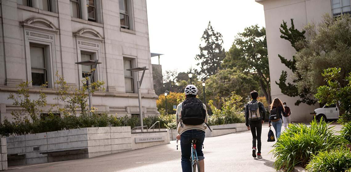 Students biking past Durant Hall