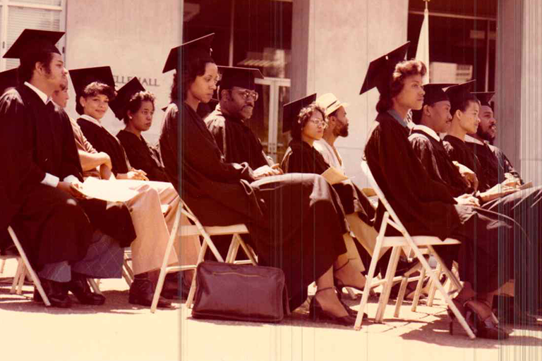 Historical image of graduates participating in Black Graduation in front of Dwinelle Hall