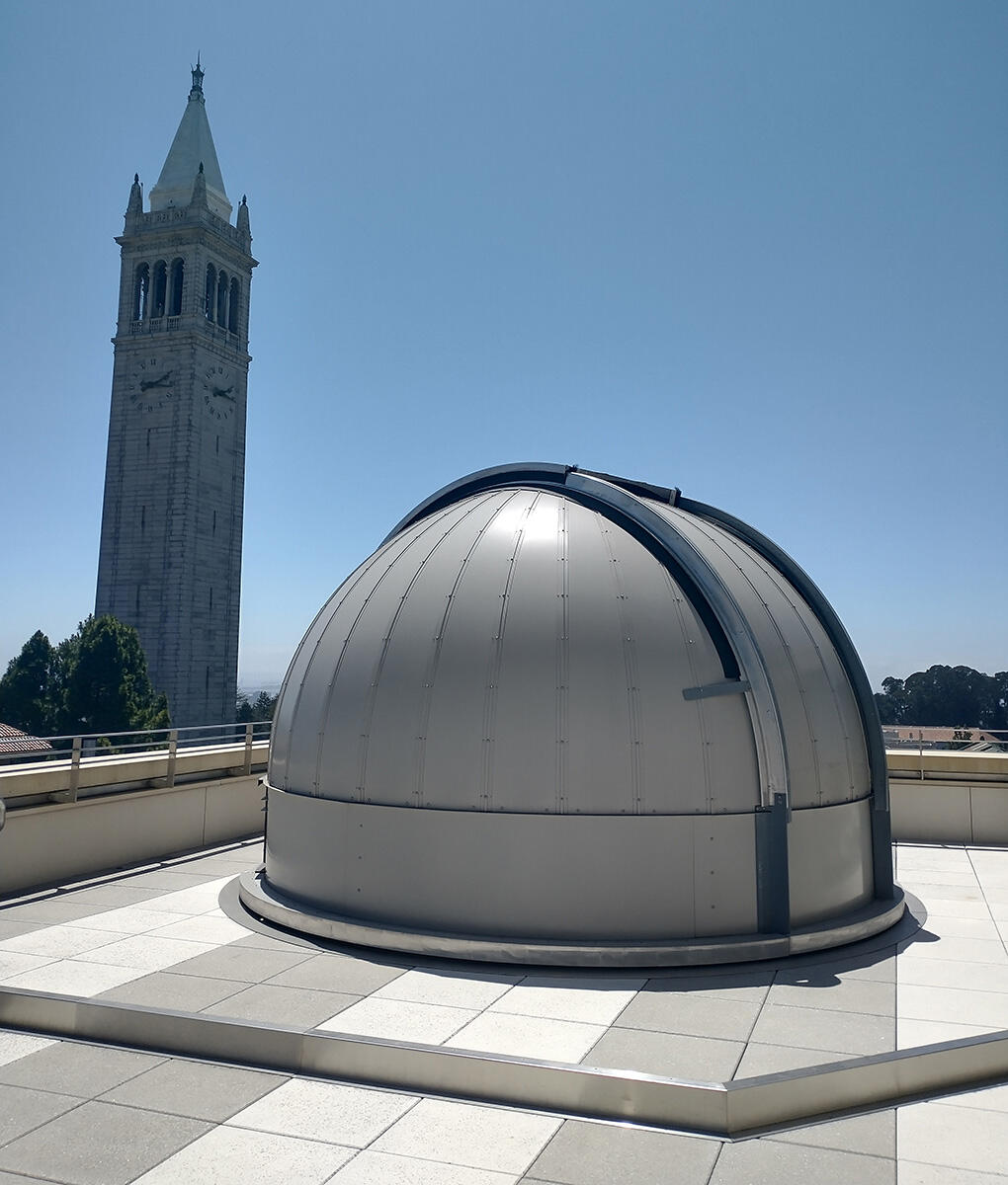 The dome of Campbell Hall's rooftop observatory in front of the Campanile.