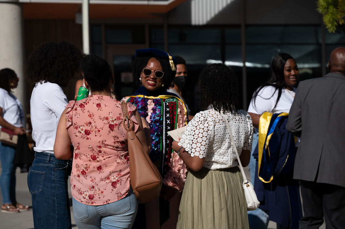 Students and friends mingling post commencement ceremony