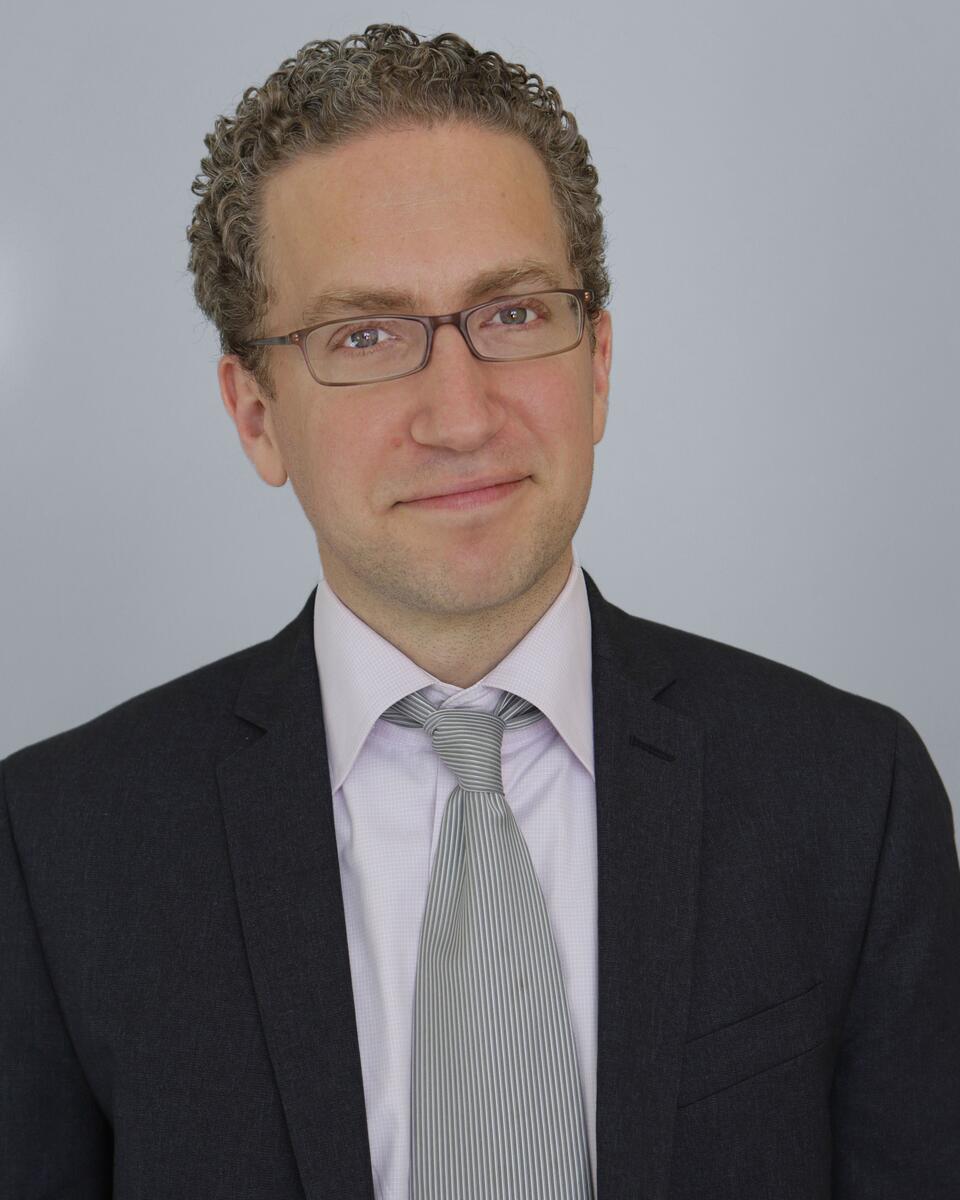 Professor Feldman with glasses smiling headshot