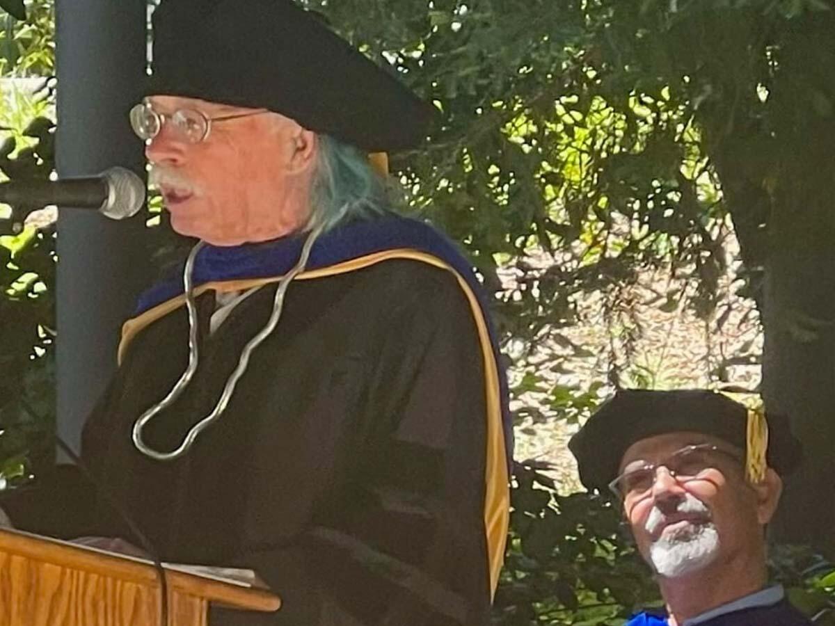 Lecturer emeritus Dr. John Hayes speaks at MELC commencement ceremony