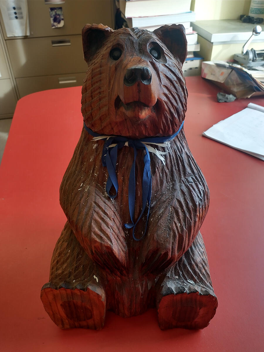 A wooden bear carving on a desk