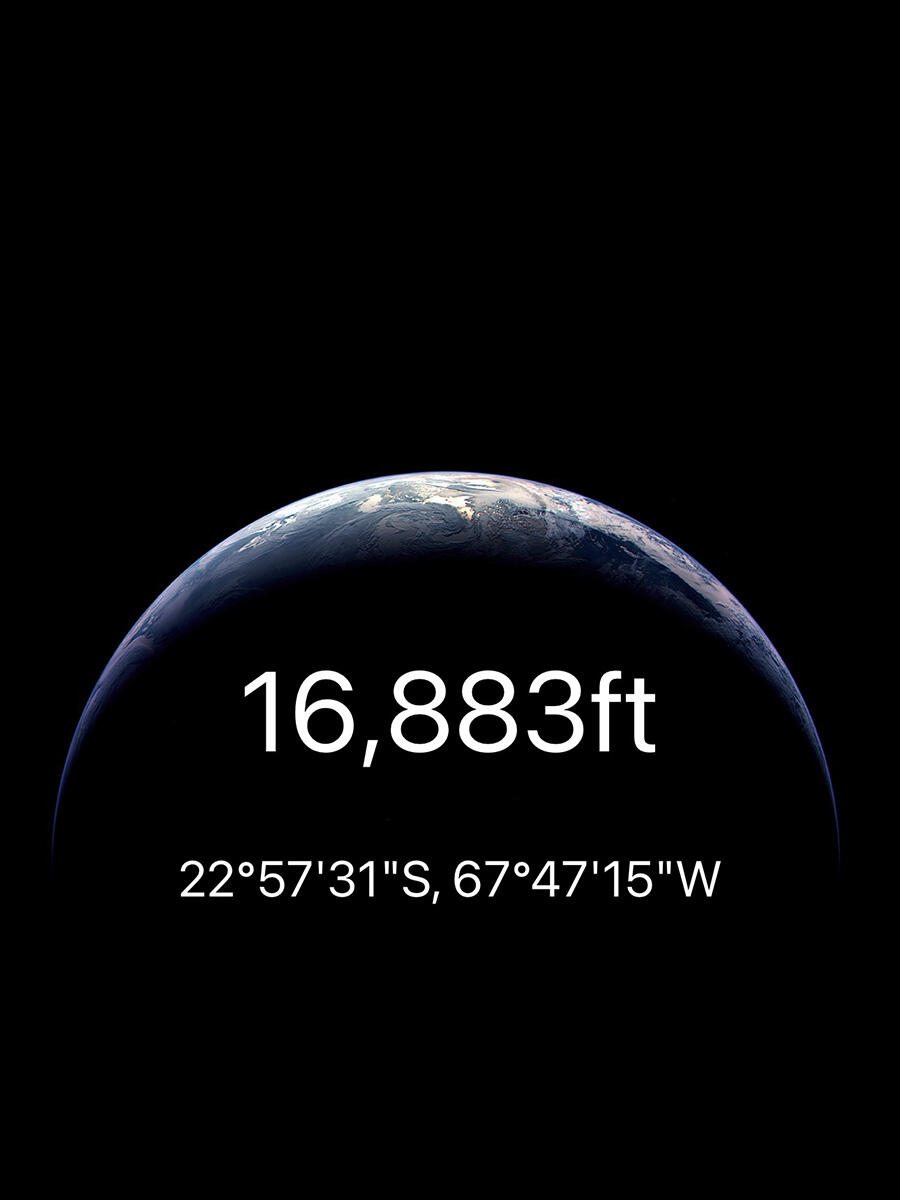 A smartphone app records an elevation of 16,883 ft.