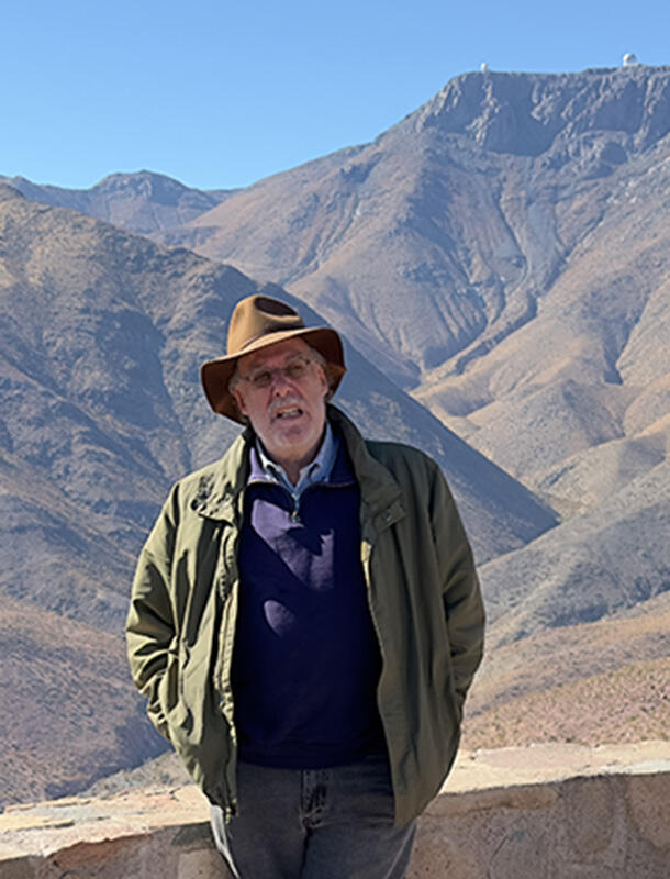 Steven Kahn stands at an overlook by the Vera C. Rubin Observatory.