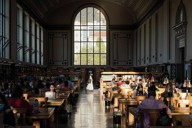 Large study hall in a library with a dome shaped window at the back