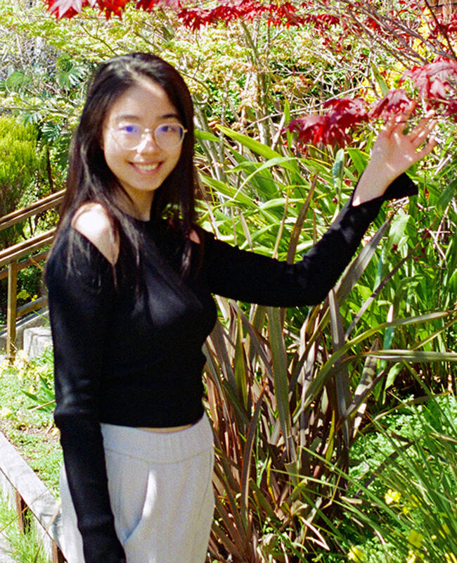 Xiaowen Liu admiring the leaves of a tree