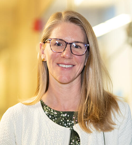 Headshot of Helen Bateup, person wearing glasses with shoulder length straight blond hair