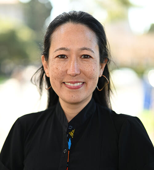Headshot of Sarah Stanley, person with short dark hair wearing a dark shirt