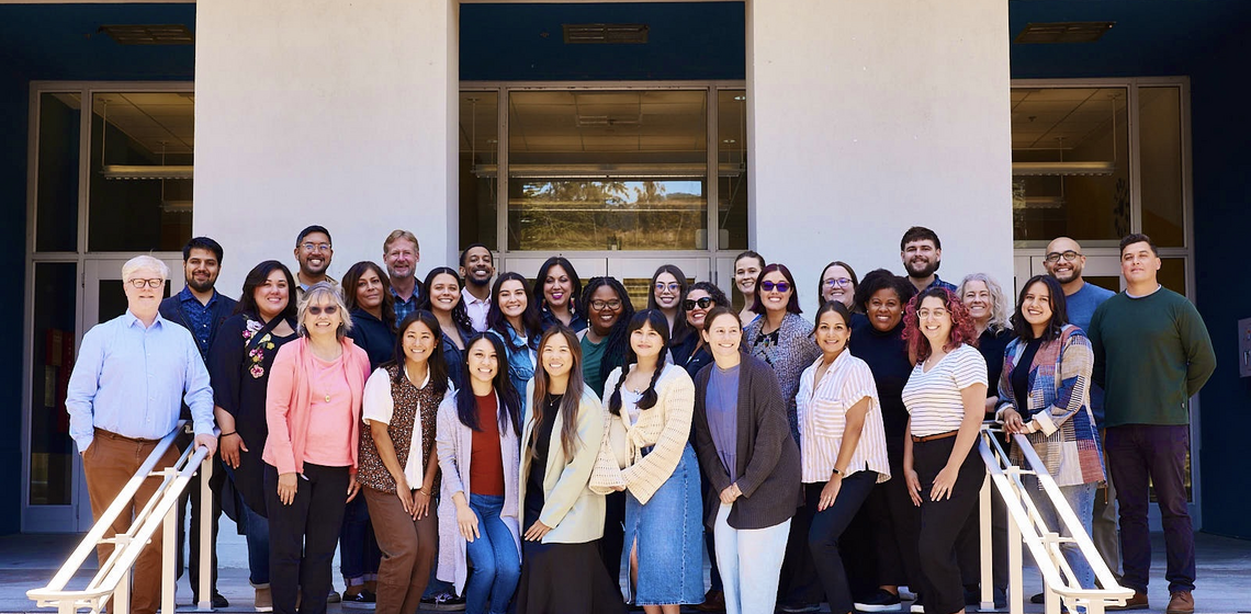 L&S Advising staff pose in a group in front of Dwinelle Hall