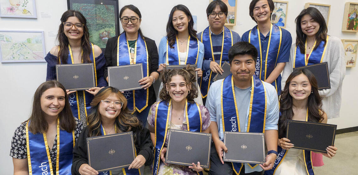 Group photo of CalTeach graduates holding diplomas