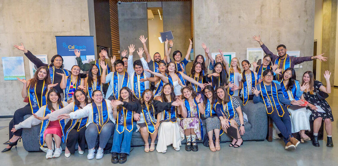 Group photo of CalTeach graduates with their arms wide