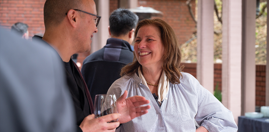 Man and woman speaking at reception