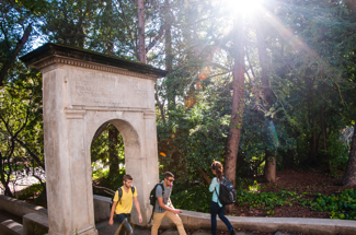 Students walking through arch on campus