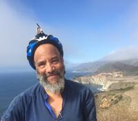Cecil Giscombe at Big Sur, wearing a bike helmet