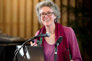 Arlie Russell Hochschild speaks at a podium