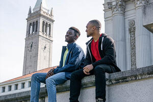 Tellum (left), ASUC president, sitting with a friend