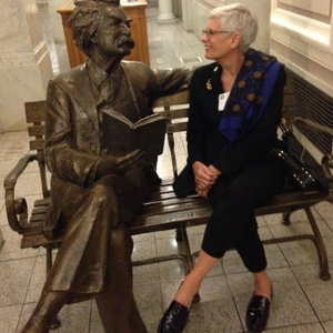 Maria Cranor sits next to statue at Berkeley