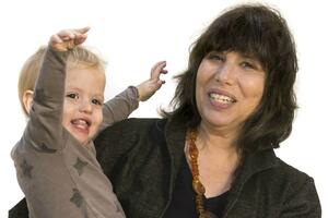 Alison Gopnik, holding her grandson Atticus, has won the coveted Rumelhart Prize in Cognitive Science