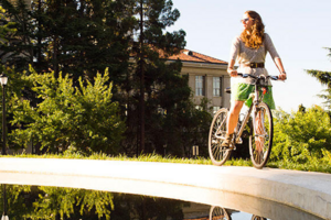Woman biking on campus