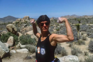 Maria Boone Cranor jokingly poses with her arms up in Joshua Tree