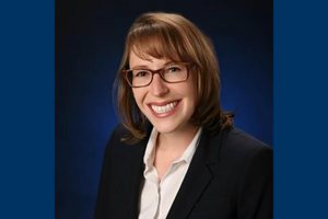 Headshot of Meg Parker '10 against navy blue background