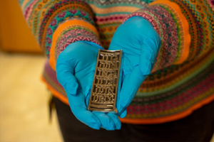 Magnes museum registrar Julie Franklin holds the mezuzah that will soon be in the vice presidential residence. 