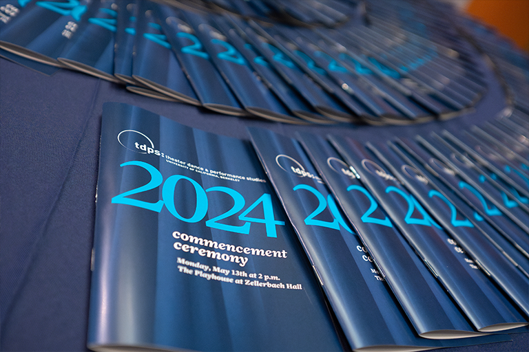 Blue commencement programs arranged in a circle