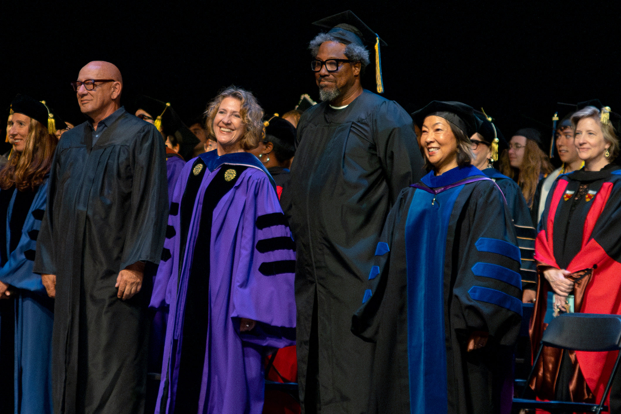 Faculty and guest pose during commencement ceremony in their regalia