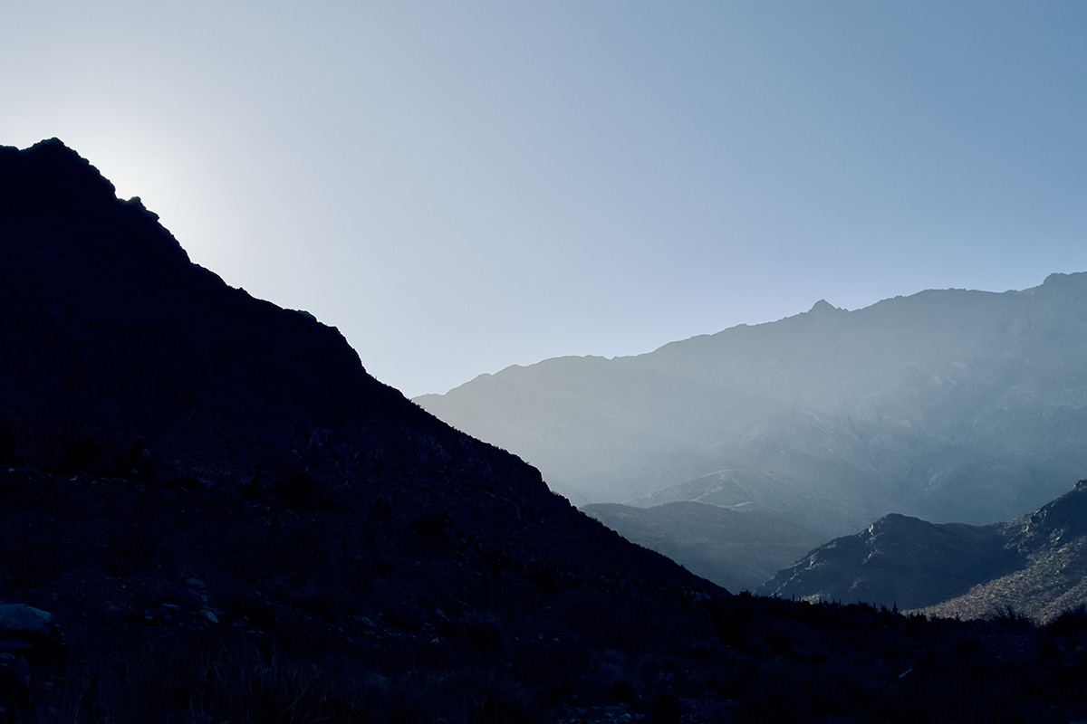 A mountainside is cloaked in shadow near the town of Vicuña, Chile.